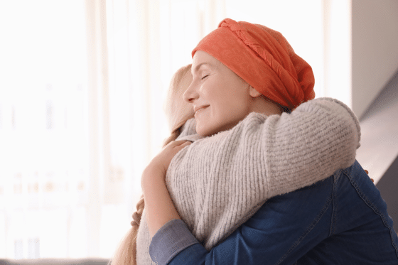 Woman with cancer hugs her daughter