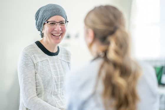A woman with cancer discusses treatment with her doctor
